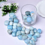 Natural Aquamarine tumbled stones bulk collection with various blue shades and patterns