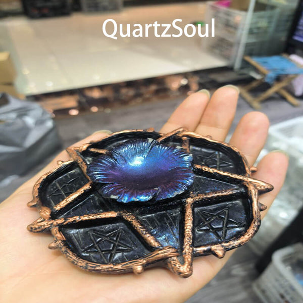 Handcrafted pentagram crystal ball stand with copper finish holding blue center sphere