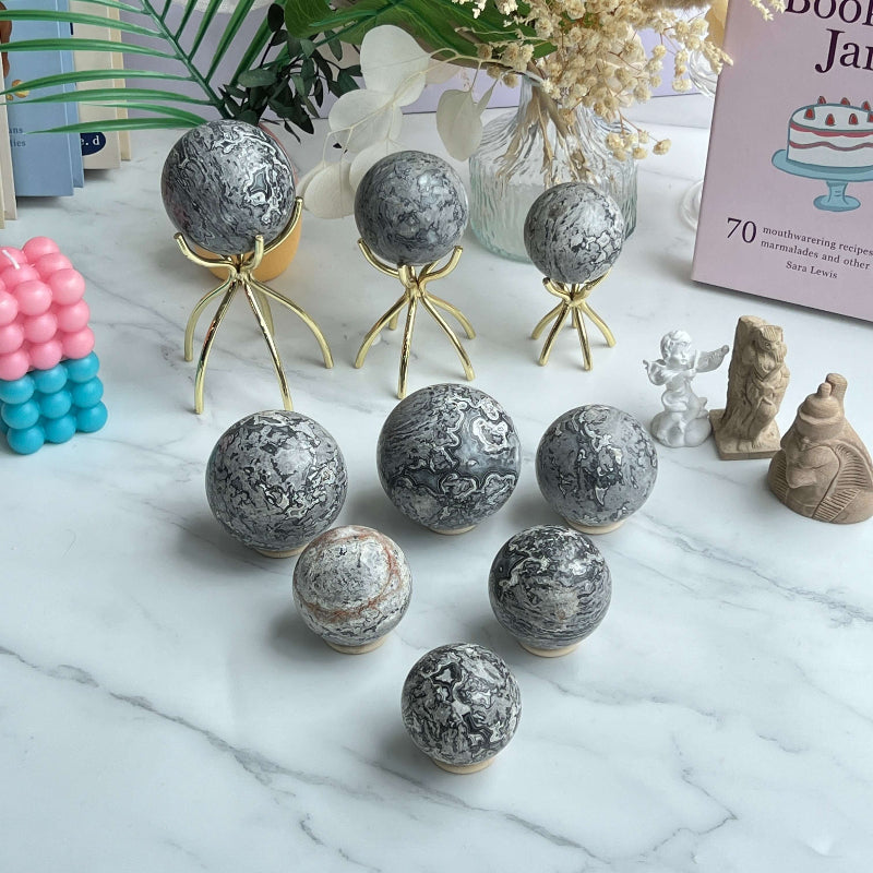 Picture Jasper Sphere on crystal display stand showing grounding energy