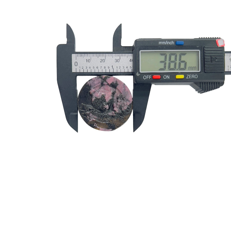 Pink rhodonite bear carving crystal on display stand