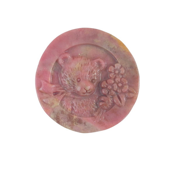 Showcase display of pink rhodonite bear carving