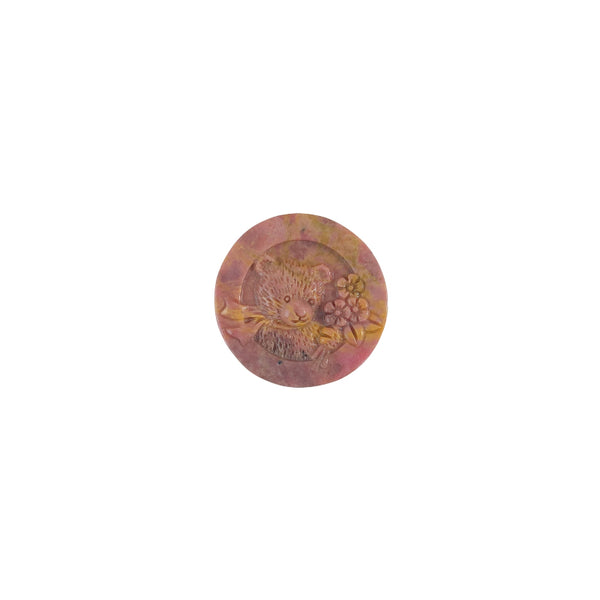 Pink rhodonite bear figurine showcasing light transmission properties