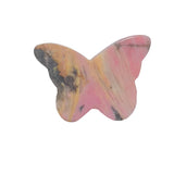 Pink rhodonite butterfly carving representing transformation and healing