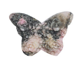 Natural inclusions and patterns in rhodonite butterfly crystal carving