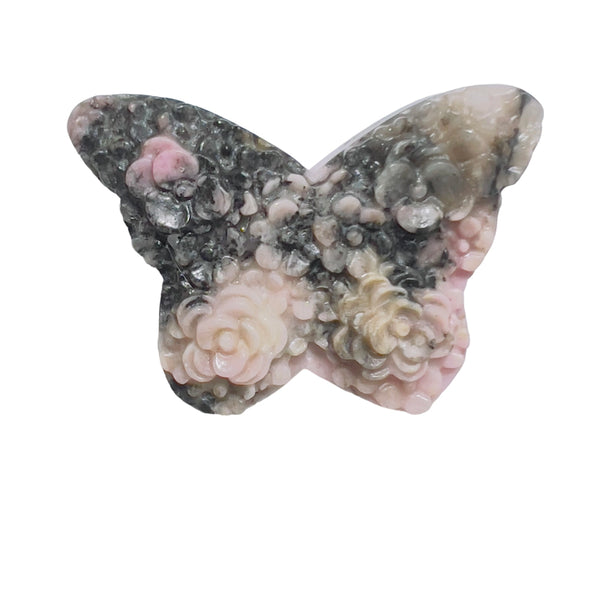 Natural inclusions and patterns in rhodonite butterfly crystal carving