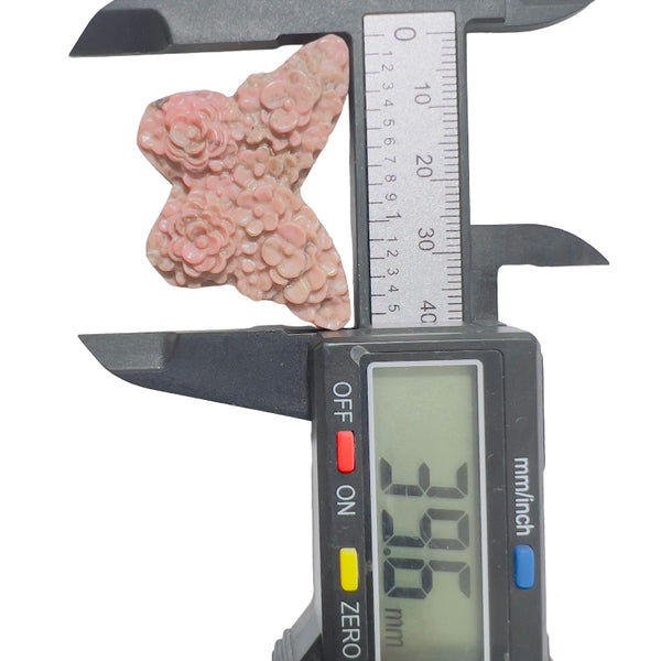 Rhodonite butterfly carving as decorative element in crystal display