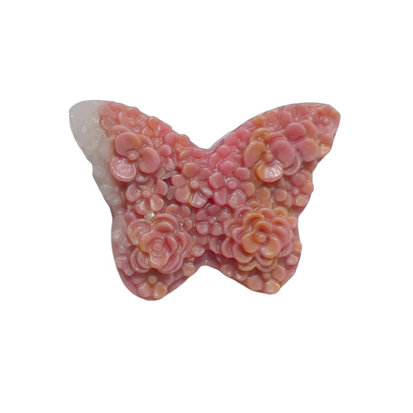 Close-up detail of rhodonite butterfly carving revealing intricate pink and black veining