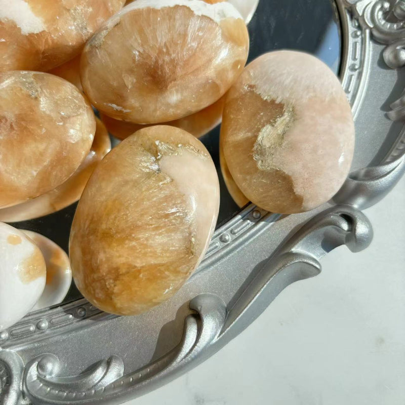 Pink Scolecite Palm Stone Placed on Chakra Points