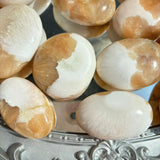 Collection of Pink Scolecite Palm Stones for Retail Display