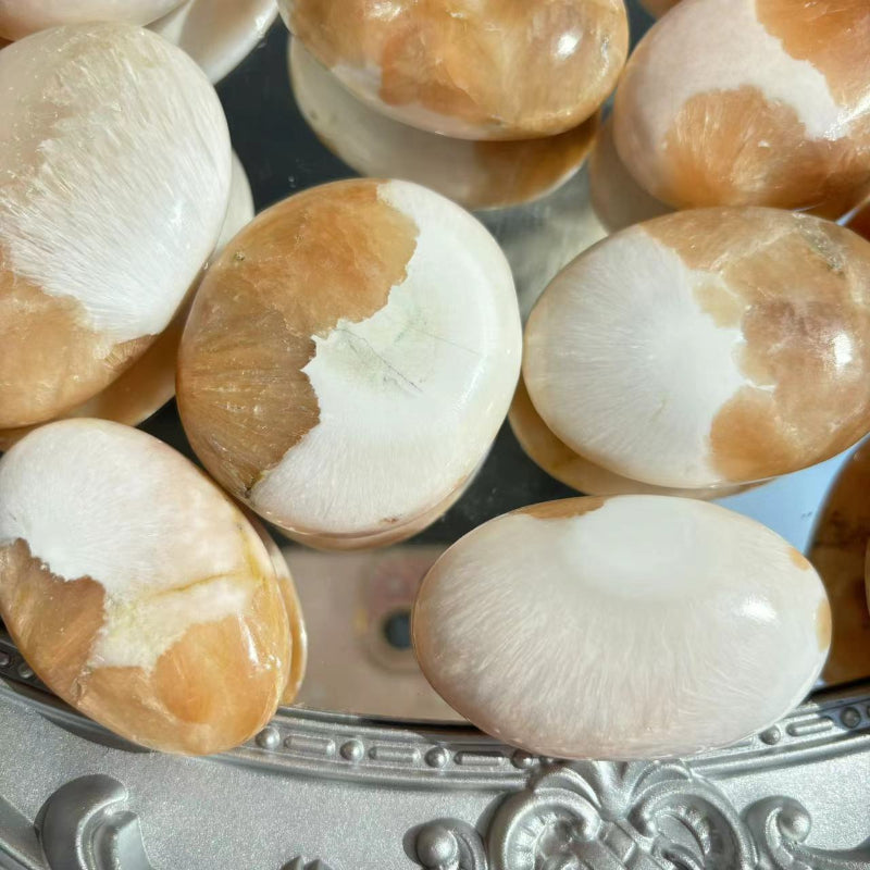 Collection of Pink Scolecite Palm Stones for Retail Display