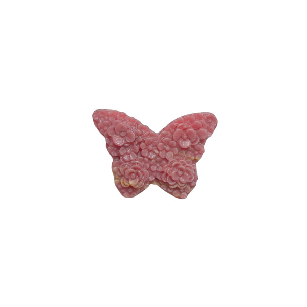 Rhodonite butterfly carving held in palm showing size proportion