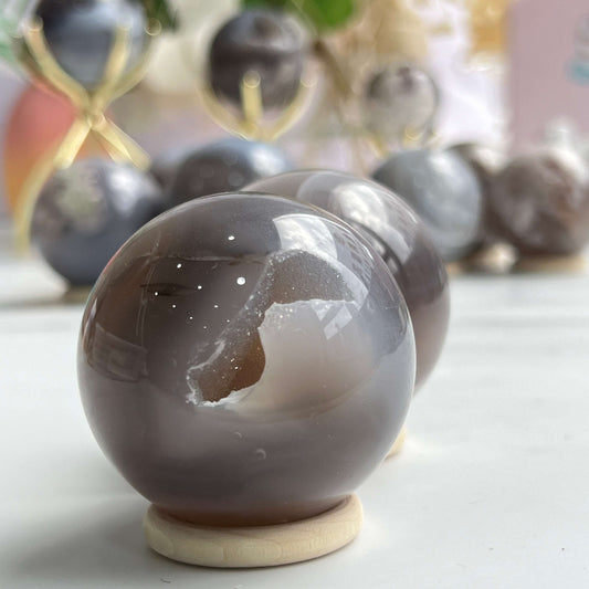 Premium Flower Agate Sphere with pink and white floral patterns for crystal healing