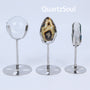 Premium silver crystal display stands showcasing clear quartz sphere, agate specimen, and crystal point