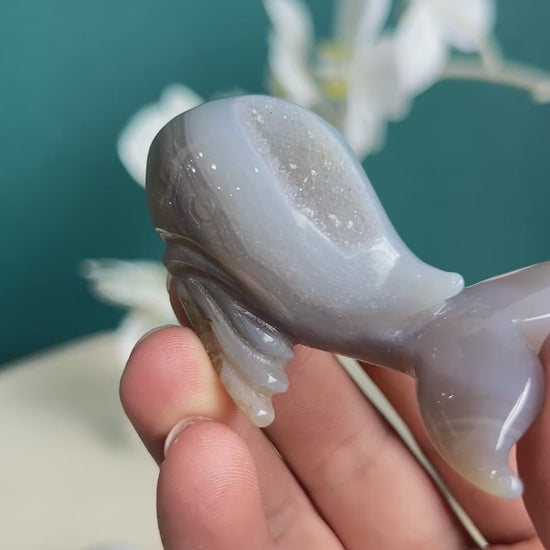 Dolphin agate crystal carving with palm size comparison showing actual dimensions