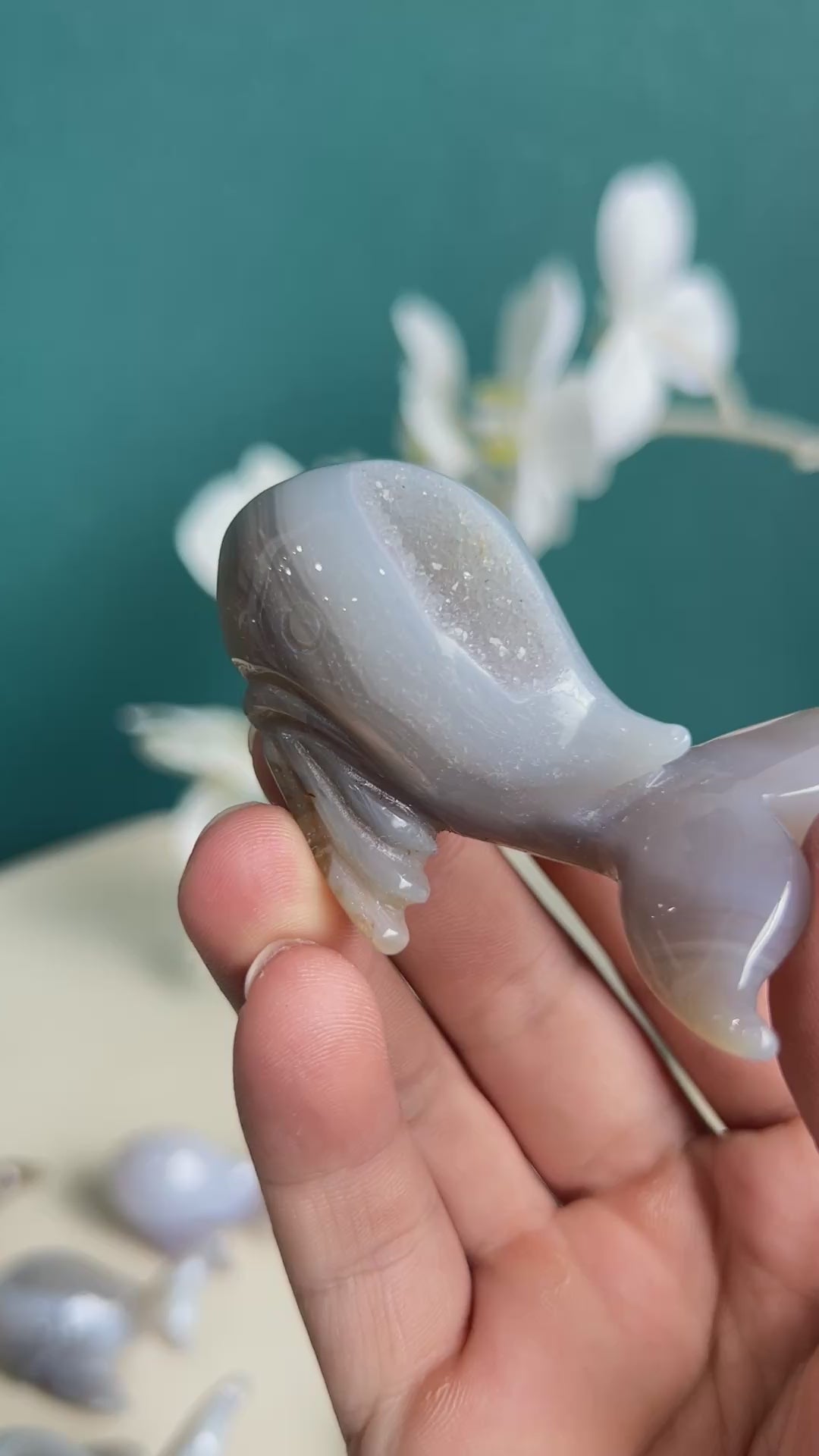 Dolphin agate crystal carving with palm size comparison showing actual dimensions