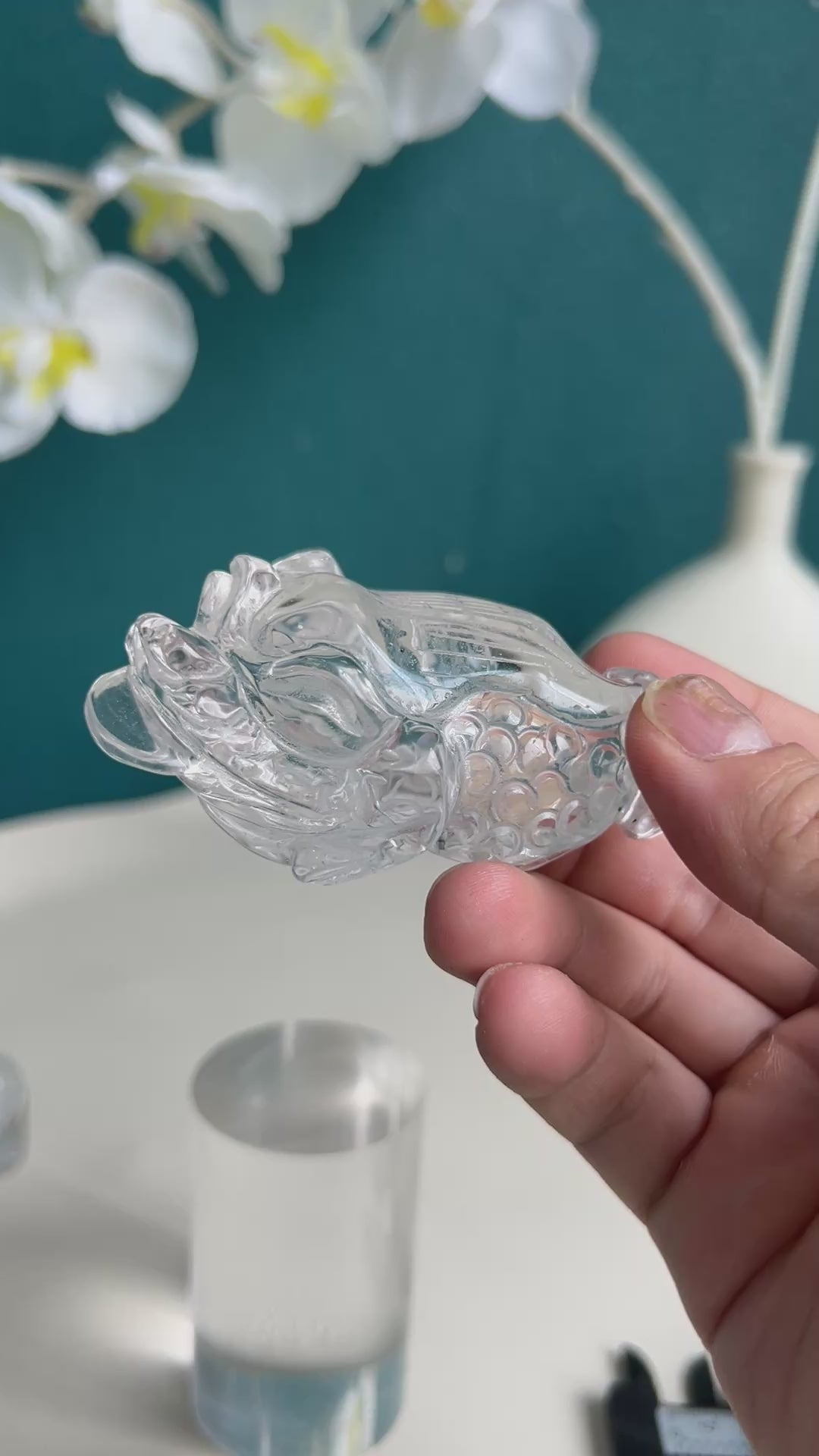 Clear quartz golden toad crystal carving shown with size perspective