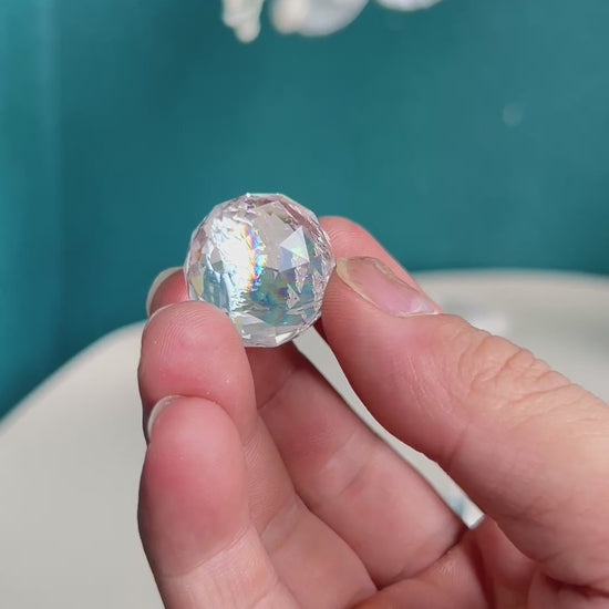 Collection of premium Clear Quartz carved crystal spheres displaying varied internal characteristics