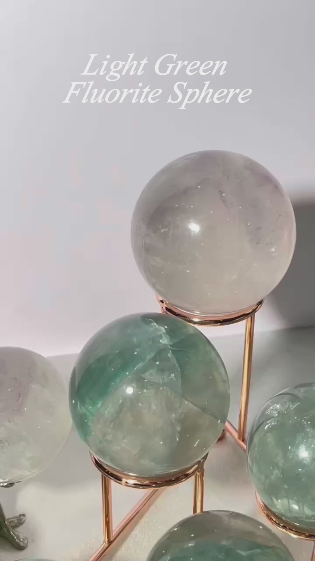 Clear light green fluorite sphere showing internal structure