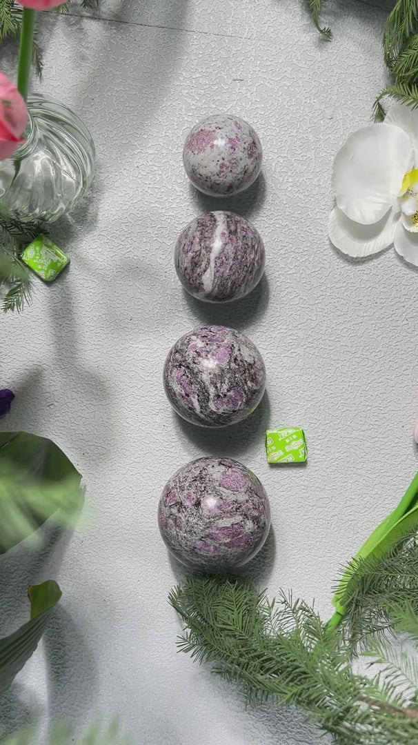 Pink tourmaline sphere catching light showing internal clarity