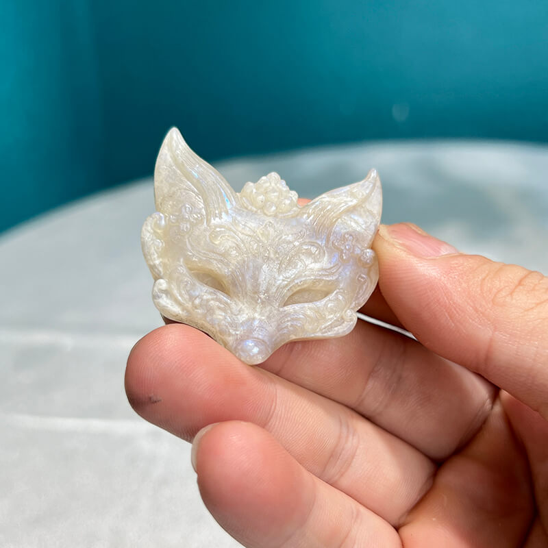 Moonstone fox carving displaying natural blue flash in lighting