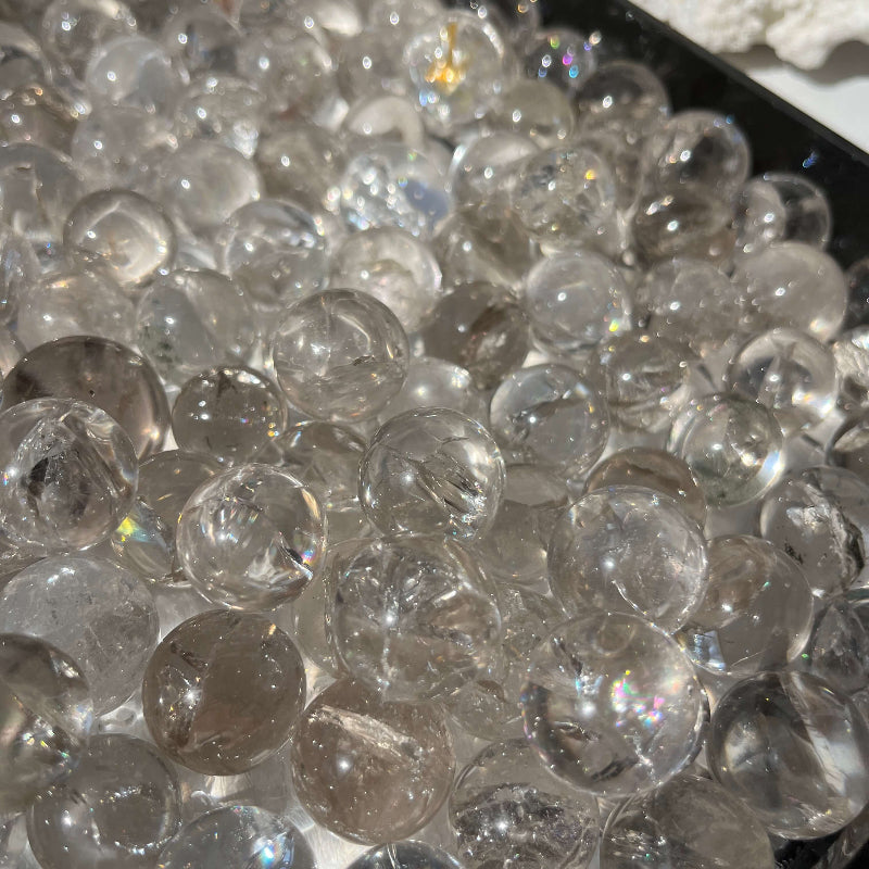 Clear quartz sphere with rainbow effects for meditation practices