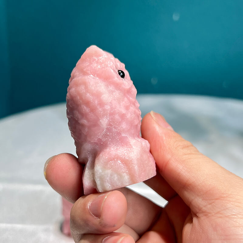 Raw Pink Opal Material Alongside Finished Carved Sculpture
