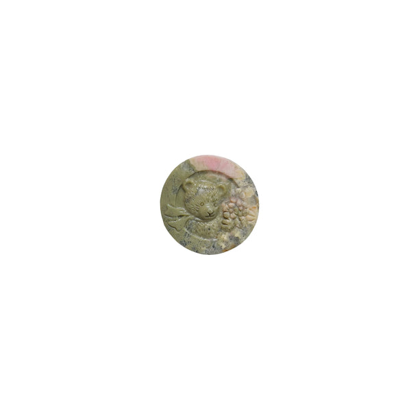 Bear shape rhodonite crystal carving as focal point in crystal grid