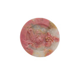 Close up rhodonite bear carving showing natural black matrix pattern
