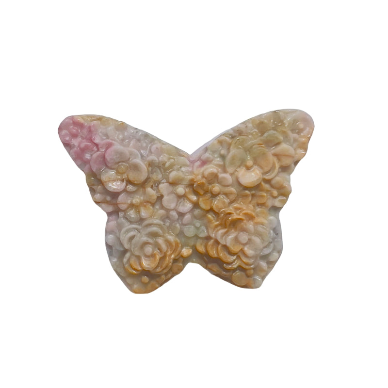 Rhodonite butterfly crystal carving being measured showing size