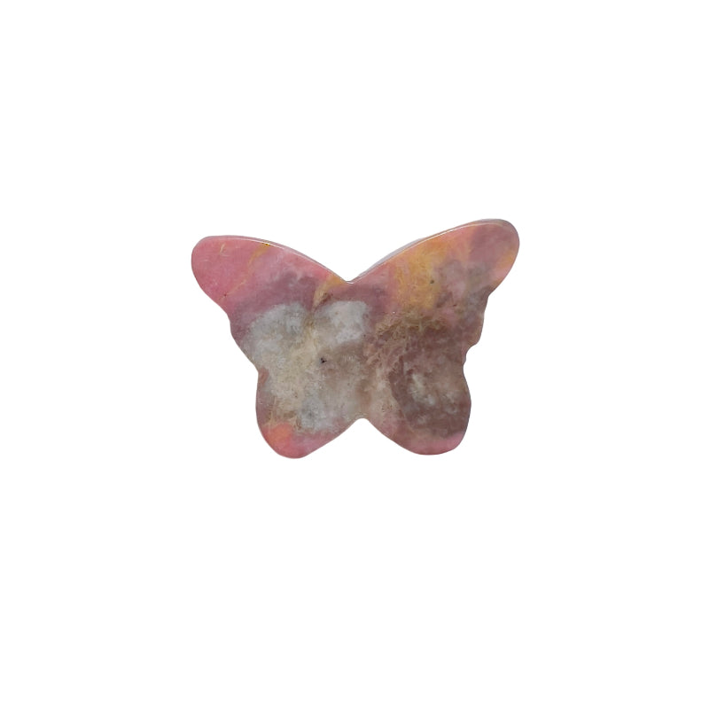 Rhodonite butterfly carving in meditation setup with complementary crystals