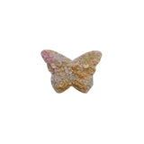 Side view of pink rhodonite butterfly carving showing natural stone pattern