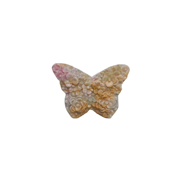 Side view of pink rhodonite butterfly carving showing natural stone pattern