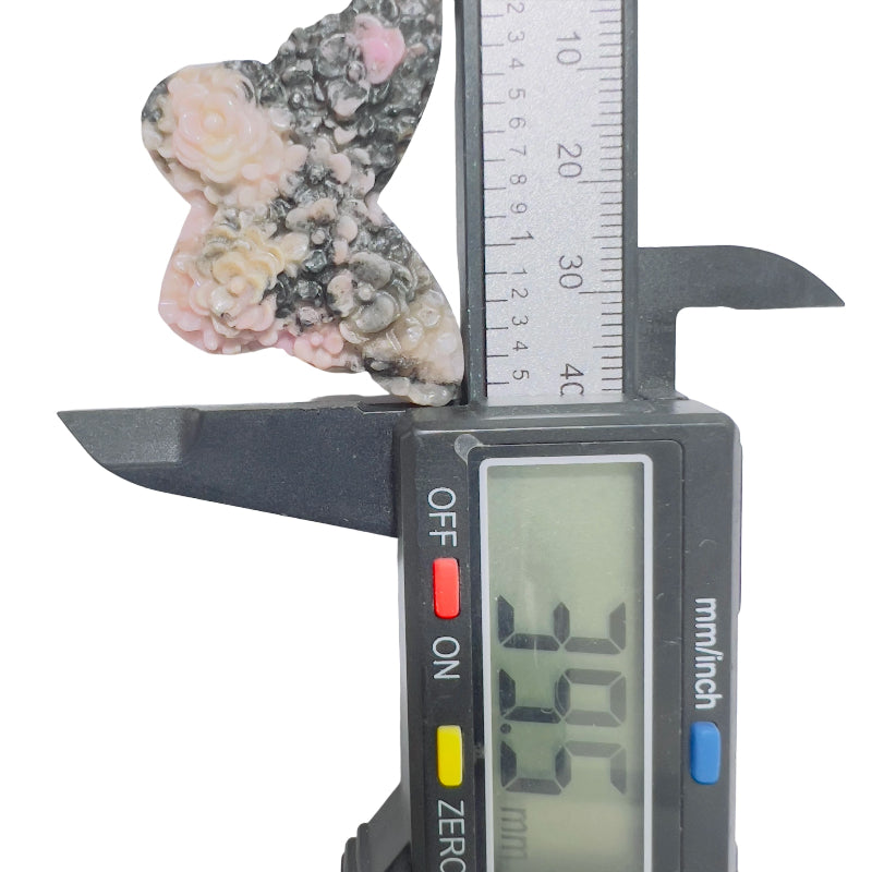 Rhodonite butterfly as centerpiece in crystal healing grid arrangement