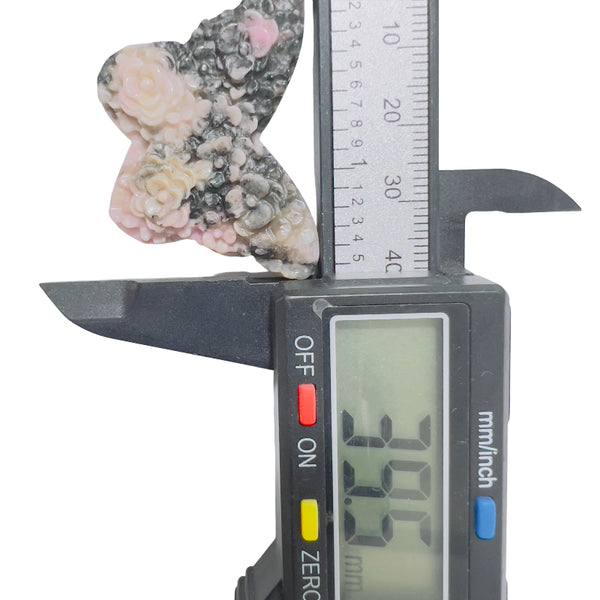 Rhodonite butterfly as centerpiece in crystal healing grid arrangement