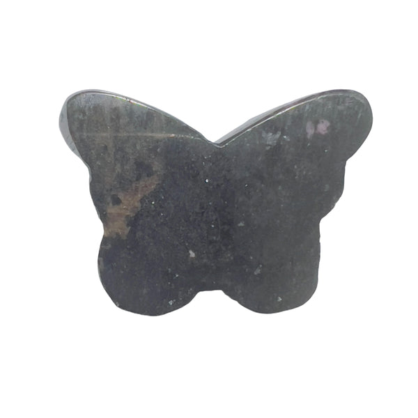 Rhodonite butterfly carving in crystal healing layout for heart chakra work