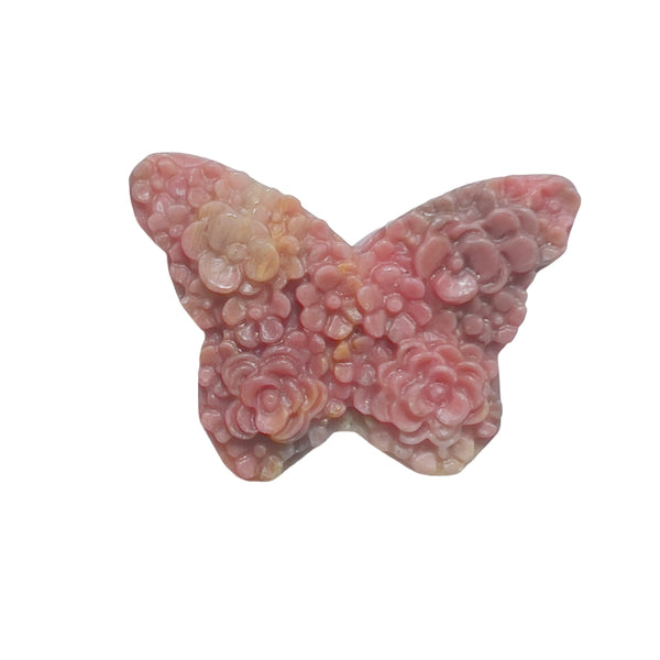 Hand holding pink rhodonite butterfly carving showing size perspective