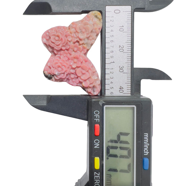 Close-up detail of butterfly rhodonite carving showing natural stone patterns