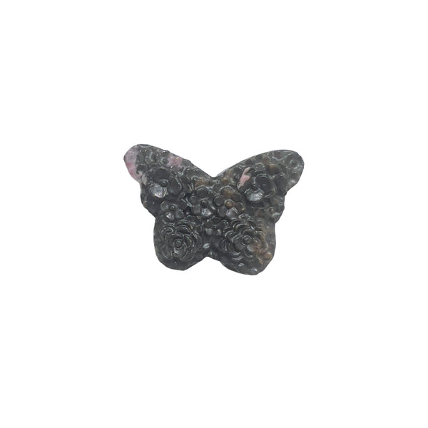 Rhodonite butterfly carving in peaceful meditation setting for emotional healing