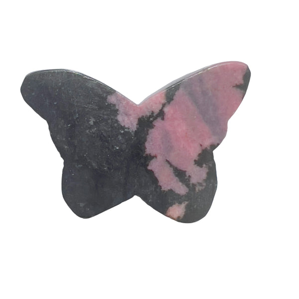 Close-up of rhodonite butterfly carving displaying natural pink color and black inclusions