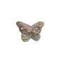 Rhodonite butterfly carving held in palm showing size perspective