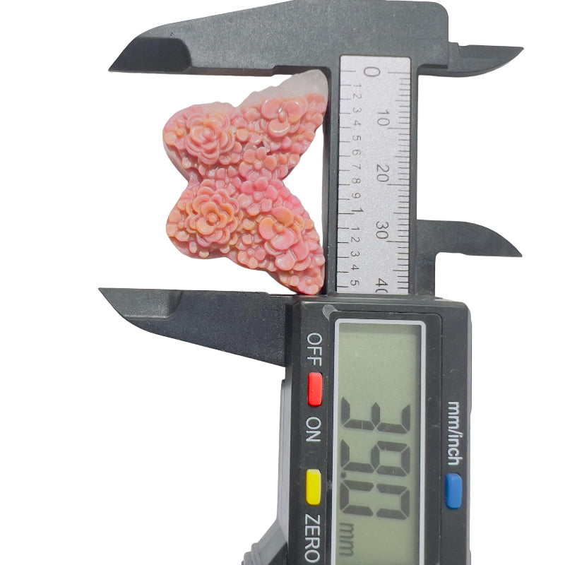 Rhodonite butterfly carving showing unique pink coloration and metaphysical properties