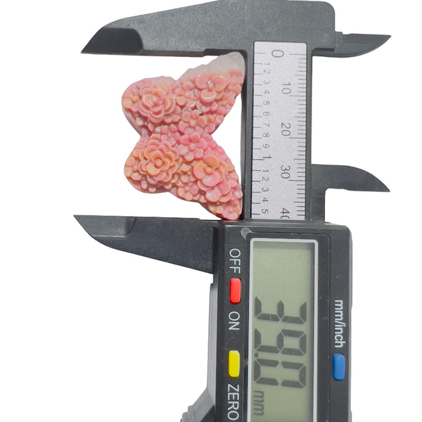 Rhodonite butterfly carving showing unique pink coloration and metaphysical properties