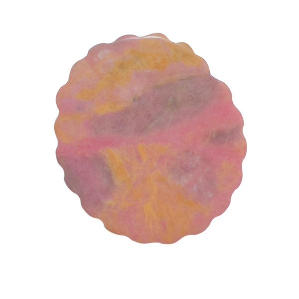 Back pattern of pink rhodonite crystal carving showing natural color variations