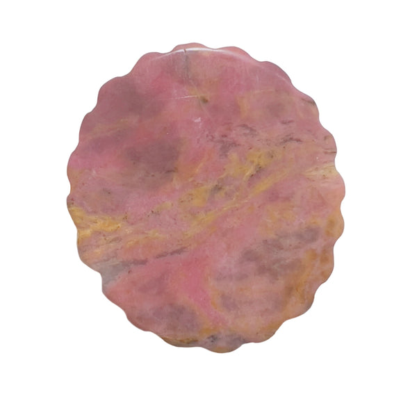 Back side of rhodonite carved medallion showing natural pink stone texture