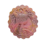 Side angle of rhodonite crystal pendant showing detailed magical girl carving