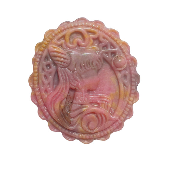 Side angle of rhodonite crystal pendant showing detailed magical girl carving