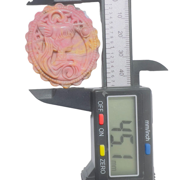 Pink rhodonite carved crystal medallion size measurement showing dimensions