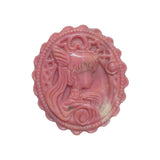 Backside of rhodonite crystal medallion showing textured grid pattern