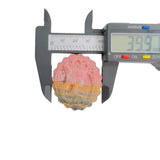Front view of pink rhodonite crystal with magical girl carving pattern