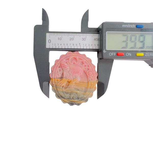 Front view of pink rhodonite crystal with magical girl carving pattern